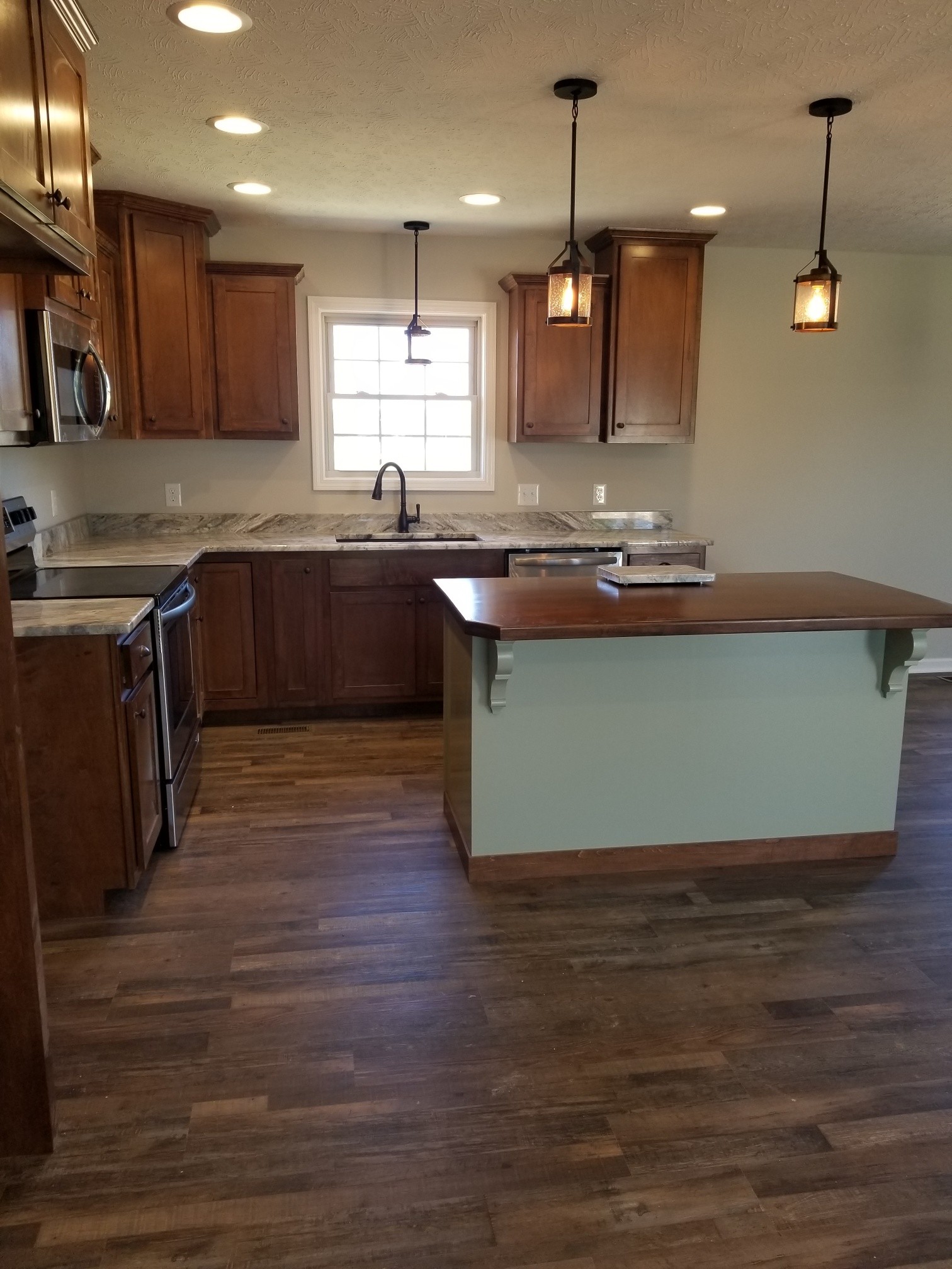 2145 Austin Road Lafayette, TN 37083 - Photo 5 of 21 a kitchen with kitchen island granite countertop wooden floors and a view of living room