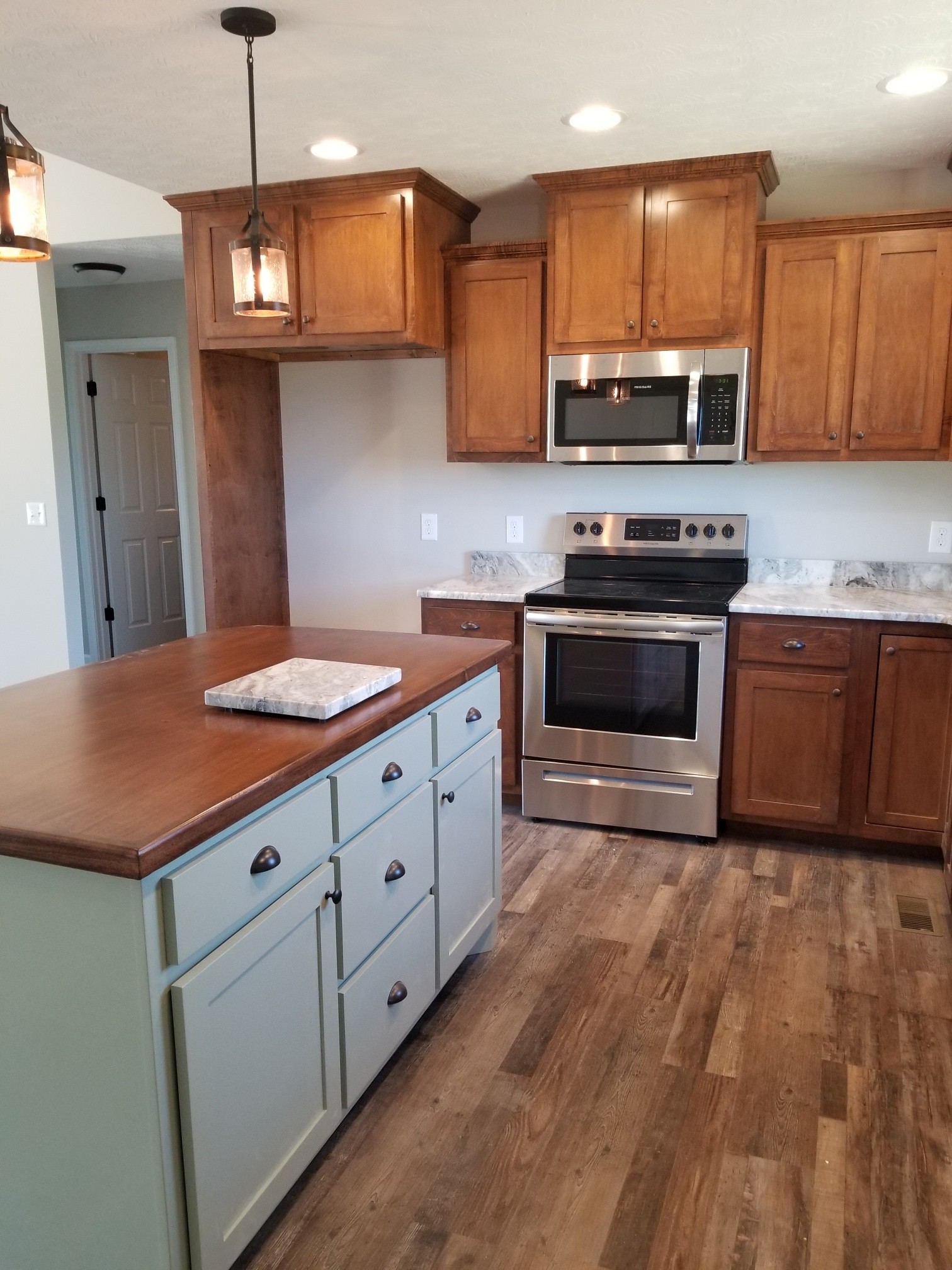 2145 Austin Road Lafayette, TN 37083 - Photo 8 of 21 a kitchen with stainless steel appliances granite countertop a stove a sink and a microwave