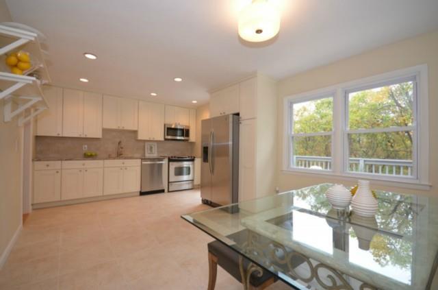 5 Senoka Drive Ridgefield, CT 06877 - Photo 1 of 1 a kitchen with stainless steel appliances granite countertop a stove a sink a refrigerator and white cabinets with wooden floor
