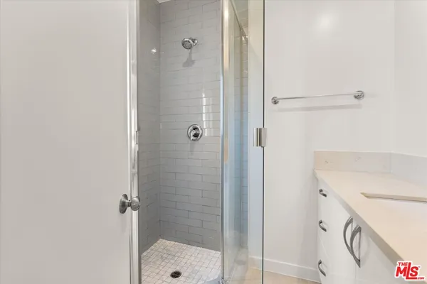 a bathroom with a shower and a sink