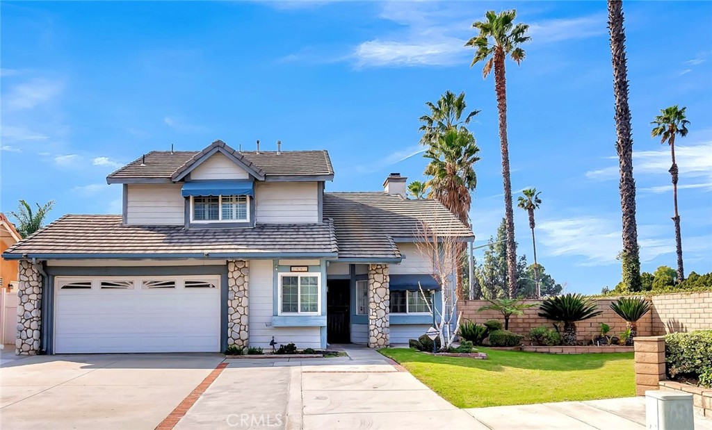 a front view of a house with a garden