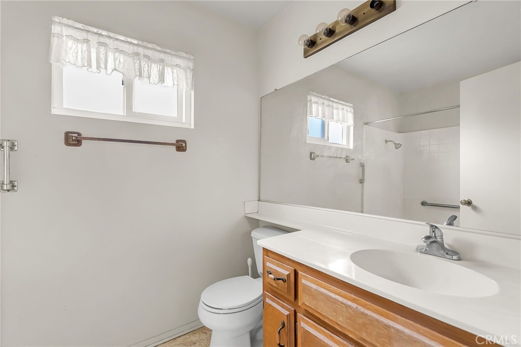 2892 Jackson Street Riverside, CA 92503 - Photo 16 of 29 a bathroom with a granite countertop sink toilet and mirror