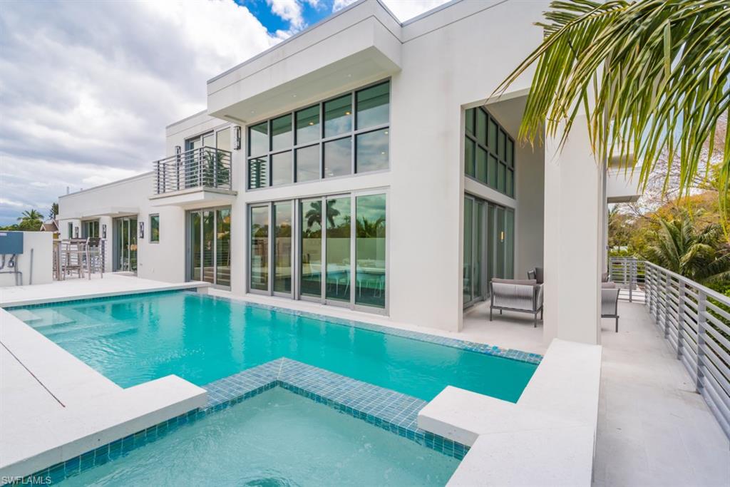 325 Banyan Boulevard Naples, FL 34102 - Photo 1 of 19 a swimming pool with outdoor view and sitting space
