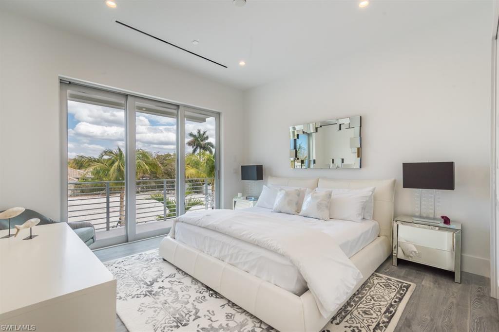 325 Banyan Boulevard Naples, FL 34102 - Photo 14 of 19 a bedroom with a large bed and a tv