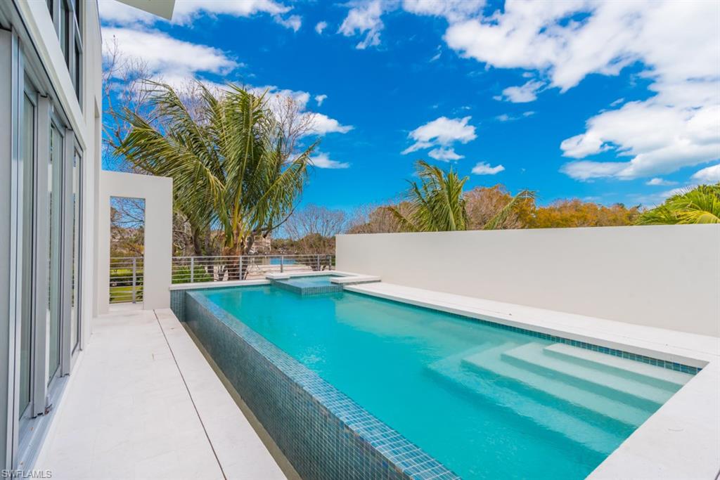 325 Banyan Boulevard Naples, FL 34102 - Photo 15 of 19 a view of swimming pool with a back yard