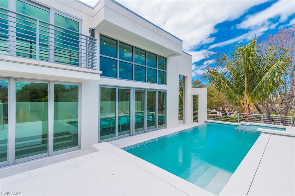 325 Banyan Boulevard Naples, FL 34102 - Photo 16 of 19 a view of a backyard with a swimming pool