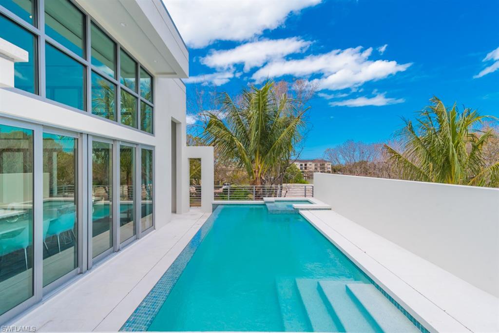 325 Banyan Boulevard Naples, FL 34102 - Photo 17 of 19 a view of a swimming pool with a yard