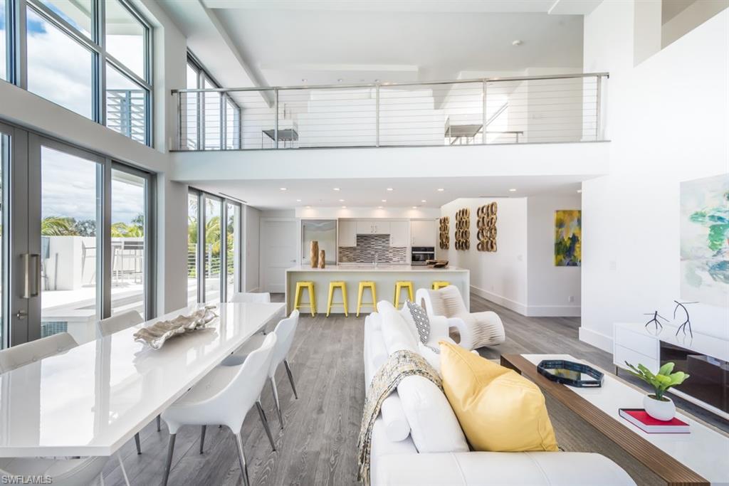 325 Banyan Boulevard Naples, FL 34102 - Photo 2 of 19 a living room with furniture and flat screen tv