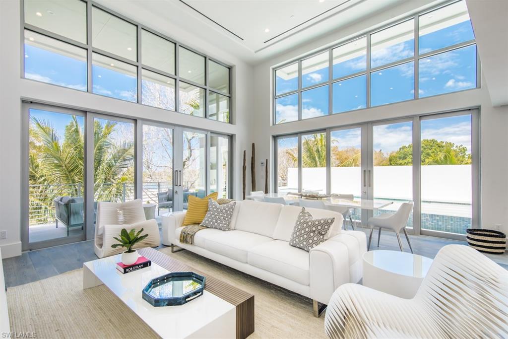 325 Banyan Boulevard Naples, FL 34102 - Photo 6 of 19 a living room with furniture and floor to ceiling windows