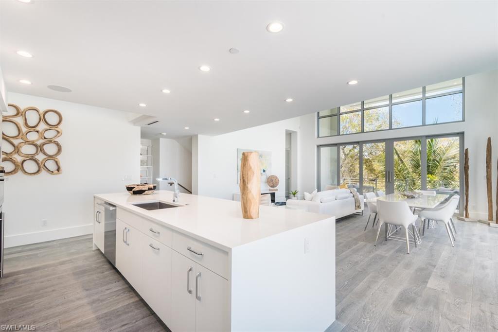 325 Banyan Boulevard Naples, FL 34102 - Photo 7 of 19 a large white kitchen with a large window