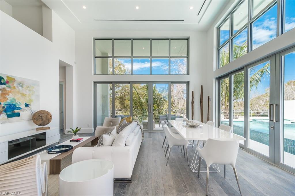 325 Banyan Boulevard Naples, FL 34102 - Photo 8 of 19 a view of a dining room with furniture water view and a floor to ceiling window