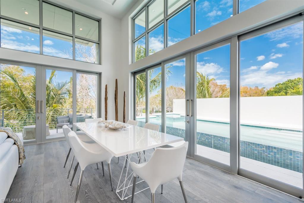 325 Banyan Boulevard Naples, FL 34102 - Photo 9 of 19 a view of a dining room with furniture window and wooden floor