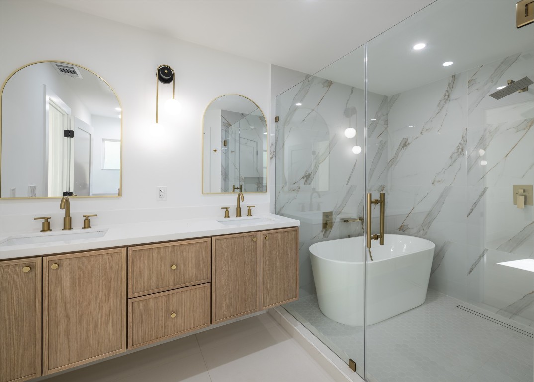 1206 Cloverleaf Drive Austin, TX 78723 - Photo 10 of 22 a spacious bathroom with a double vanity sink mirror and bathtub