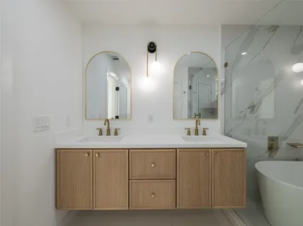 a bathroom with a sink a toilet a bathtub and shower