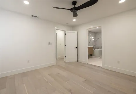 a spacious bathroom with a double vanity sink mirror and bathtub