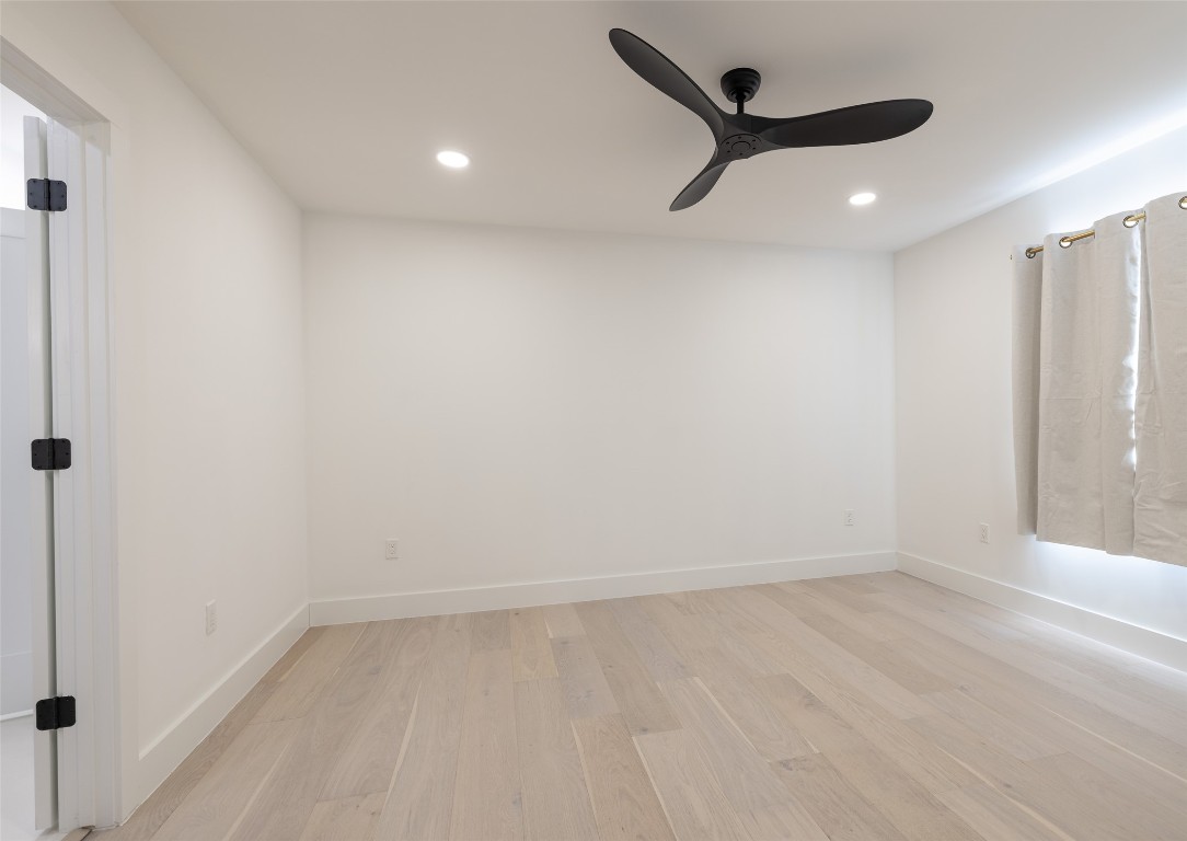 1206 Cloverleaf Drive Austin, TX 78723 - Photo 14 of 22 a view of a room with a ceiling fan and wooden floor