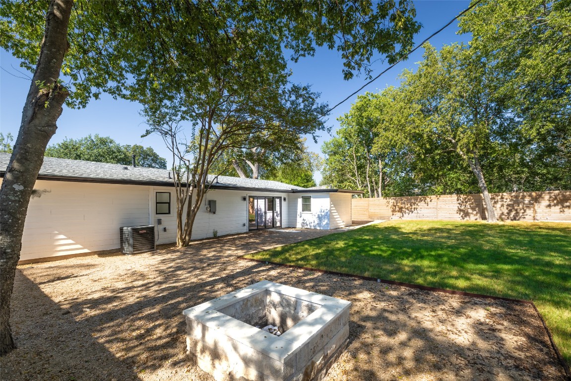 1206 Cloverleaf Drive Austin, TX 78723 - Photo 19 of 22 a backyard of a house with table and chairs