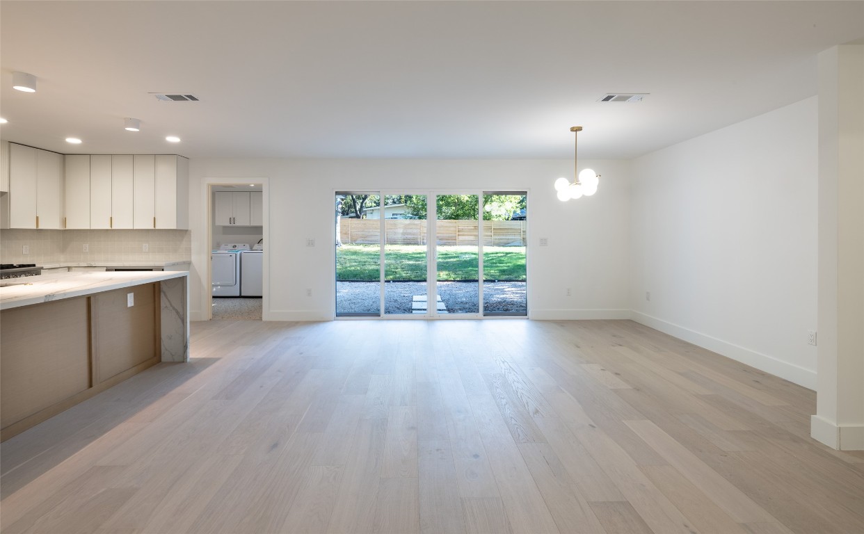 1206 Cloverleaf Drive Austin, TX 78723 - Photo 3 of 22 an empty room with wooden floor and windows