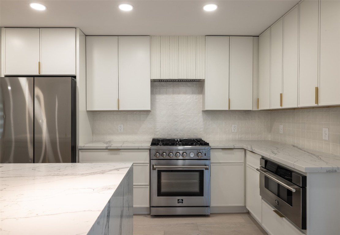 1206 Cloverleaf Drive Austin, TX 78723 - Photo 5 of 22 a kitchen with stainless steel appliances white cabinets and a stove