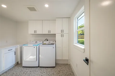 a kitchen with stainless steel appliances white cabinets and a stove