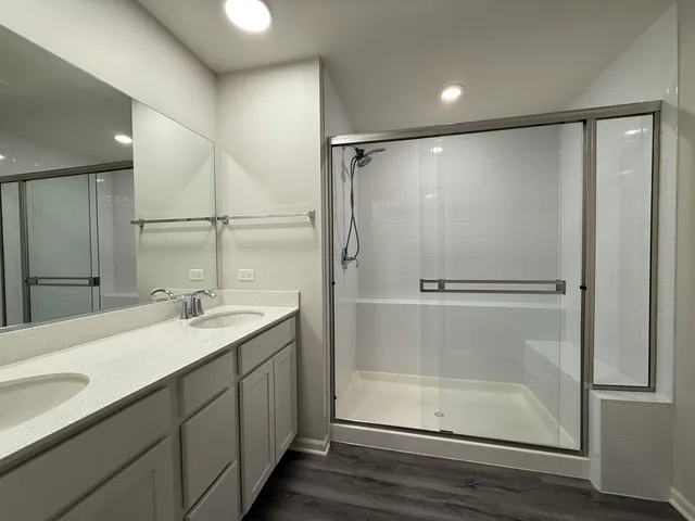 a bathroom with a shower sink and mirror