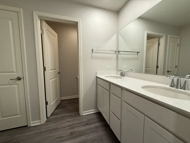 a bathroom with a double vanity sink and mirror