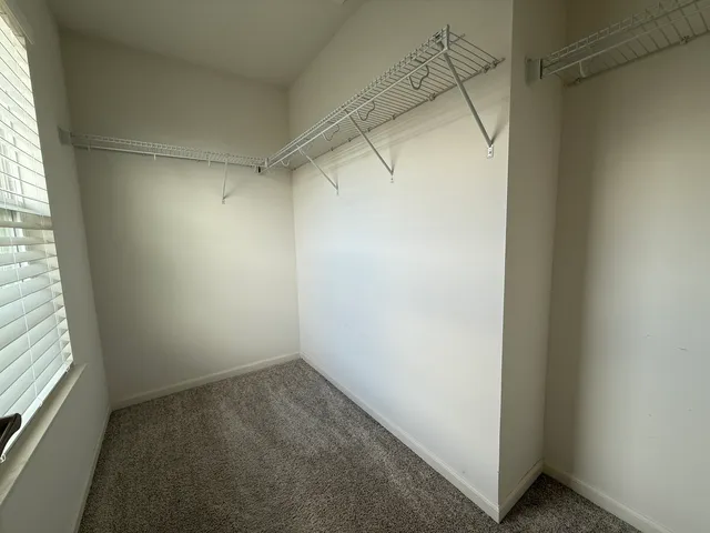 a view of a room with racks on the wall and a window