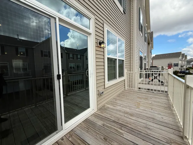 a view of a patio with wooden floor and iron stairs