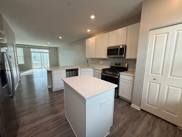 a kitchen with stainless steel appliances a refrigerator sink and microwave