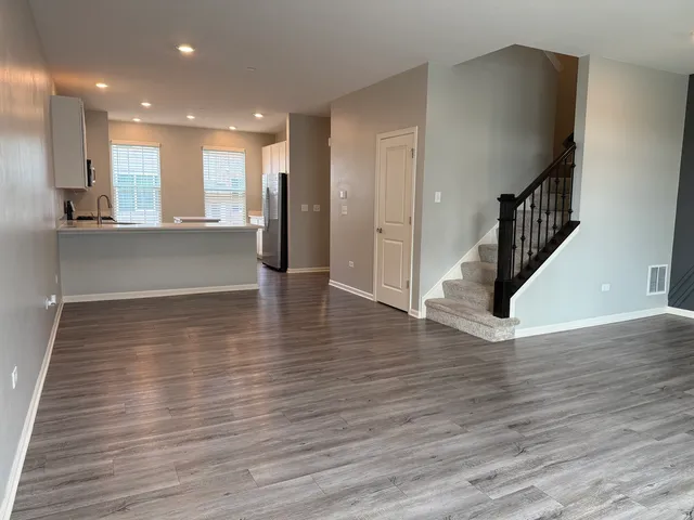 a view of entryway and hall with wooden floor