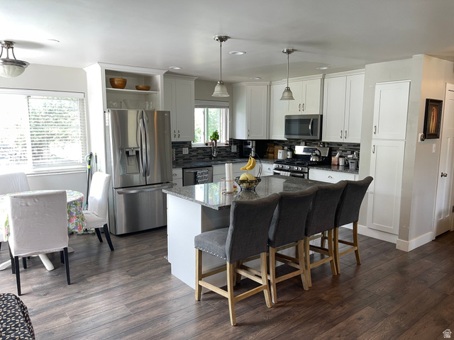 2444 Quail Run Drive Sandy, UT 84093 - Photo 4 of 23 Modern kitchen featuring a granite-topped counters and stainless steel appliance