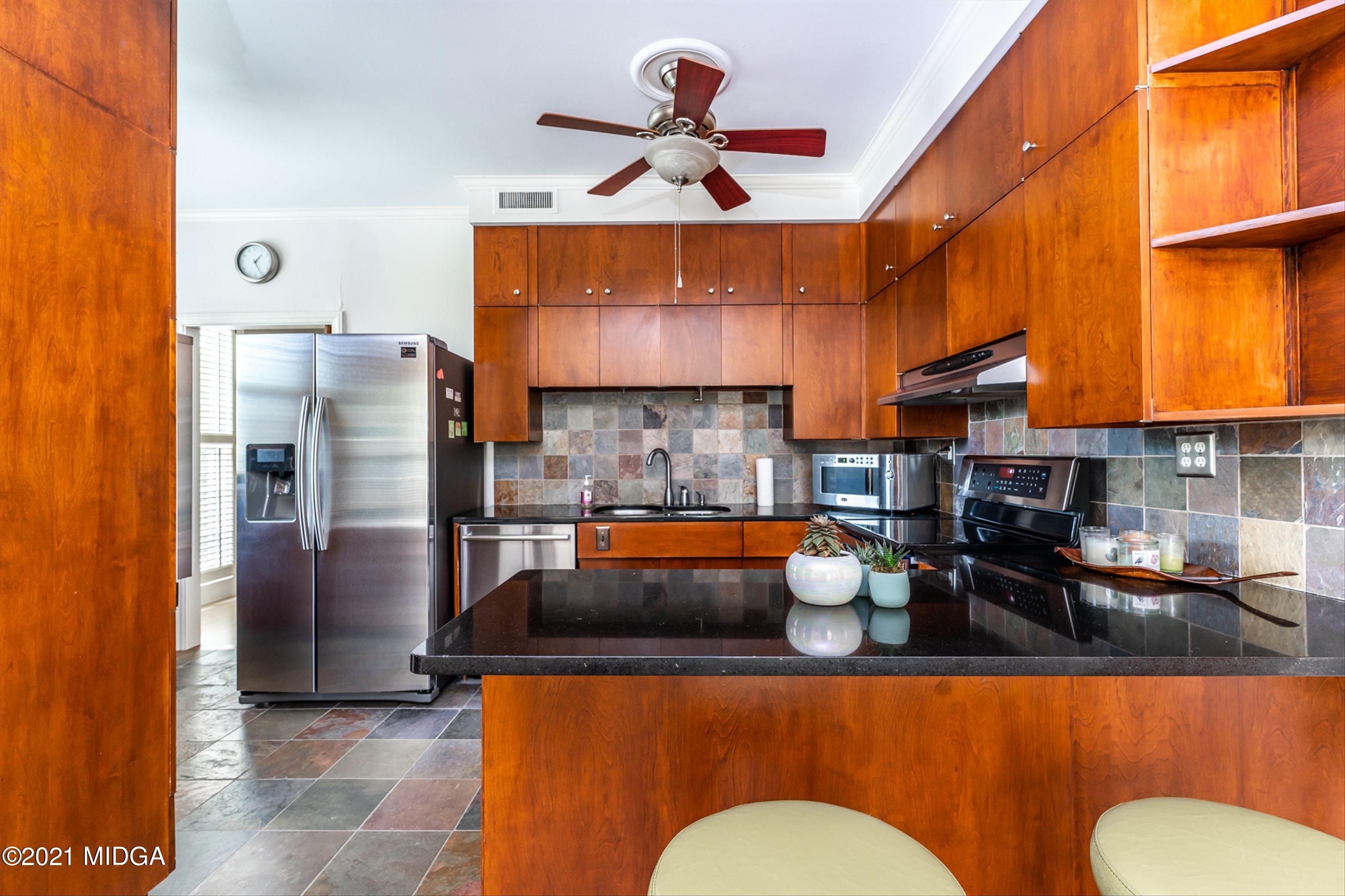 1845 Lincoln Road Macon, GA 31211 - Photo 12 of 31 a kitchen with stainless steel appliances a sink a refrigerator a stove and white cabinets