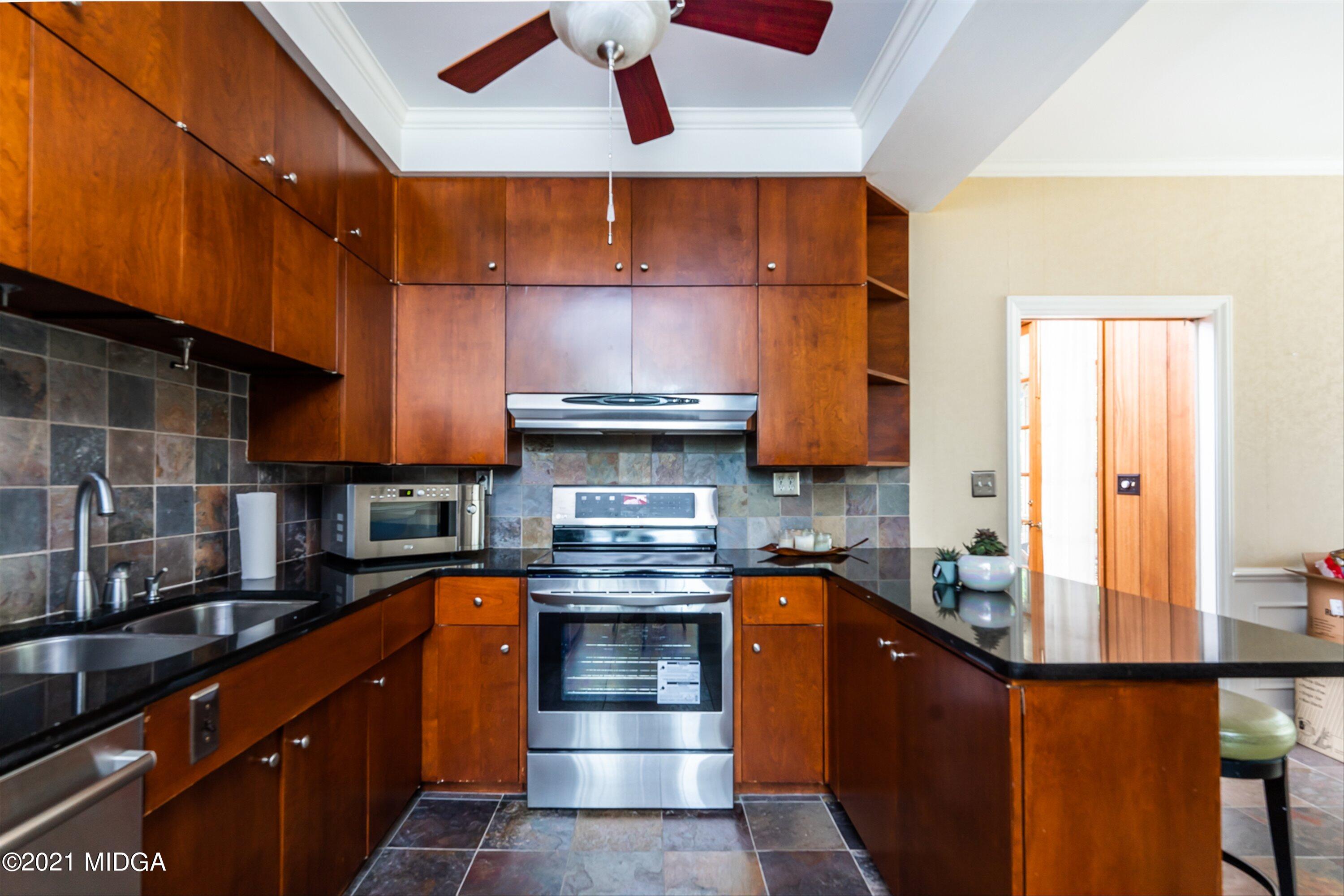 1845 Lincoln Road Macon, GA 31211 - Photo 14 of 31 a kitchen with stainless steel appliances granite countertop a stove a sink and a microwave