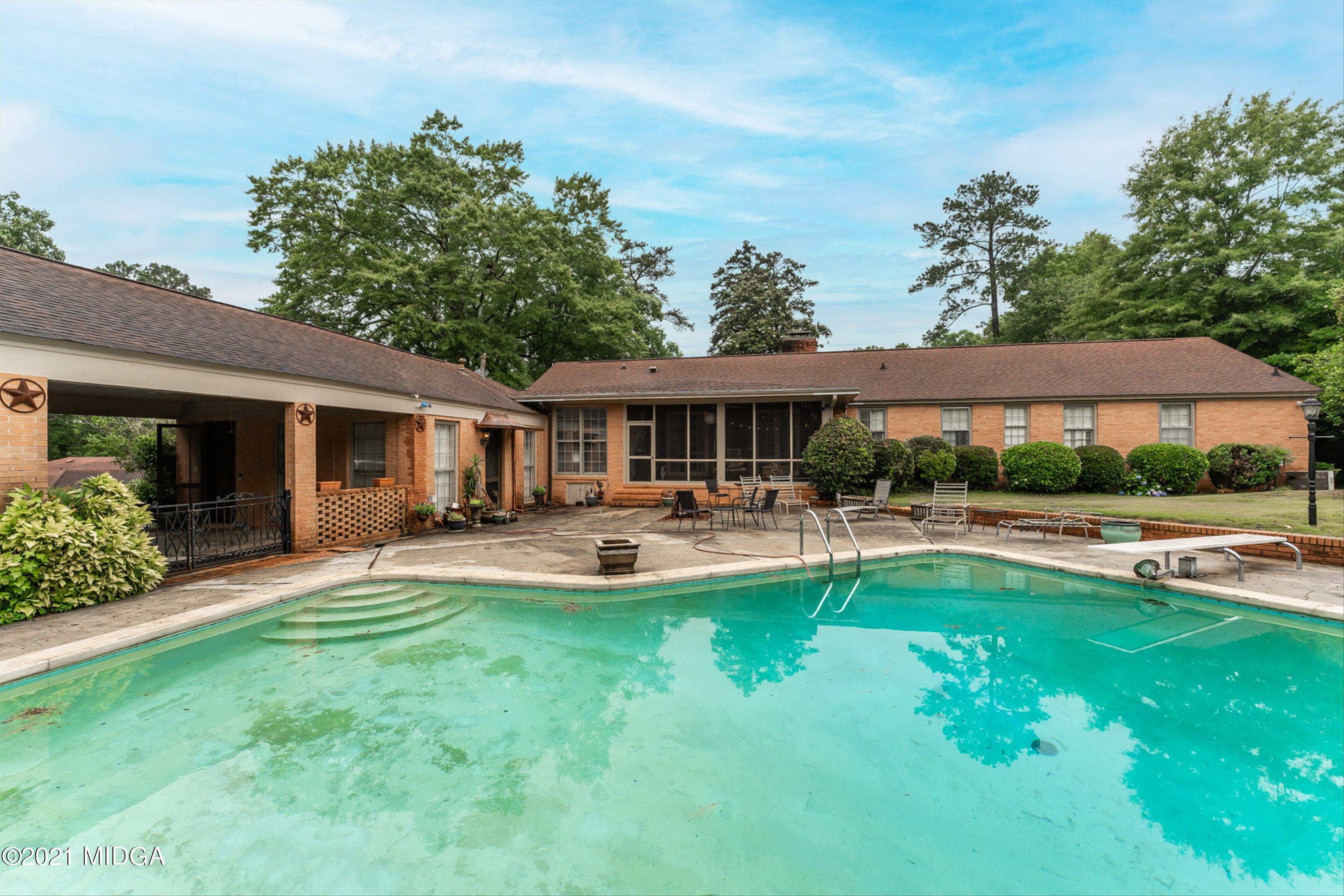 1845 Lincoln Road Macon, GA 31211 - Photo 3 of 31 a front view of a house with swimming pool having outdoor seating
