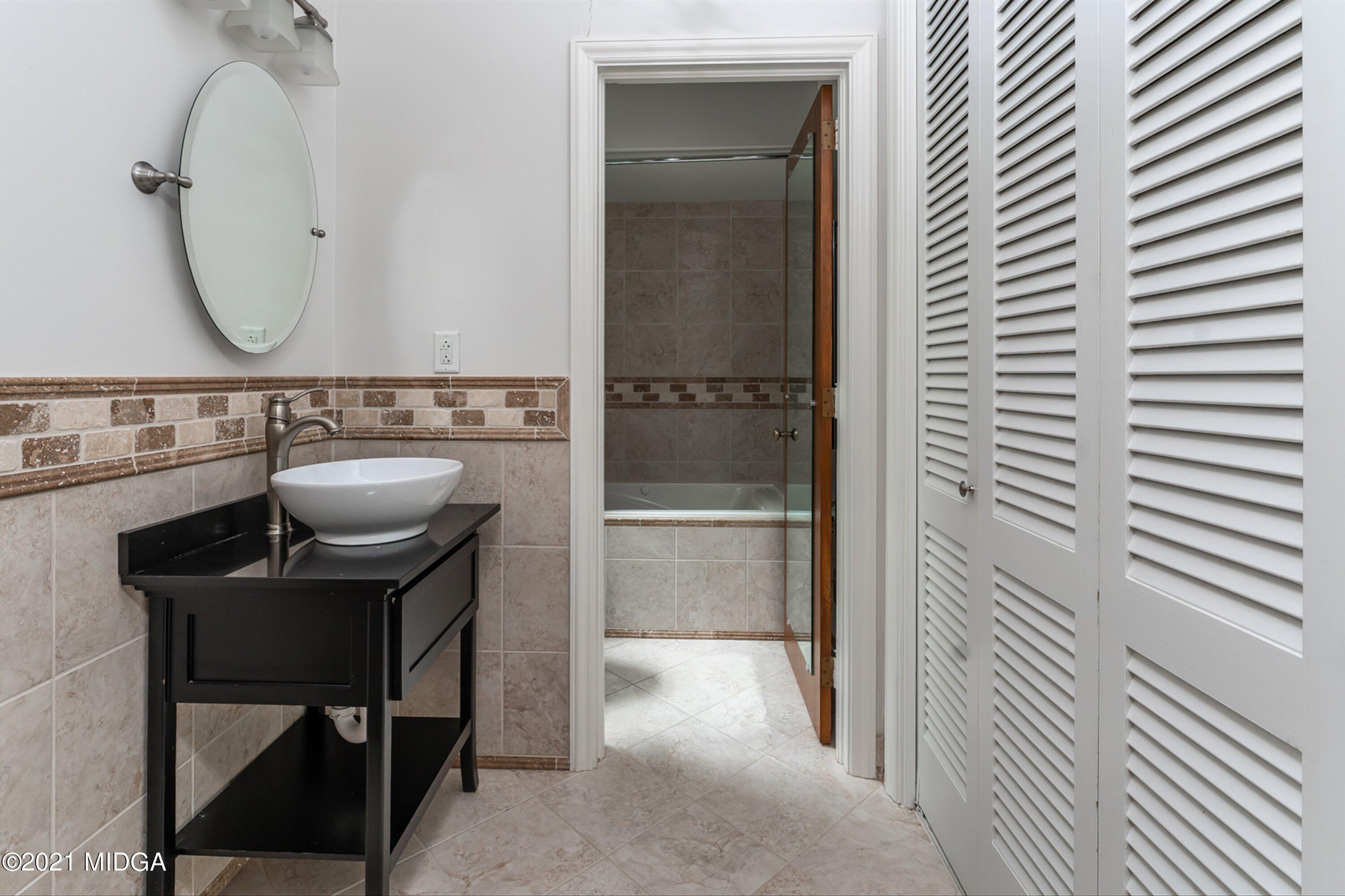 1845 Lincoln Road Macon, GA 31211 - Photo 25 of 31 a bathroom with a sink a mirror and a shower