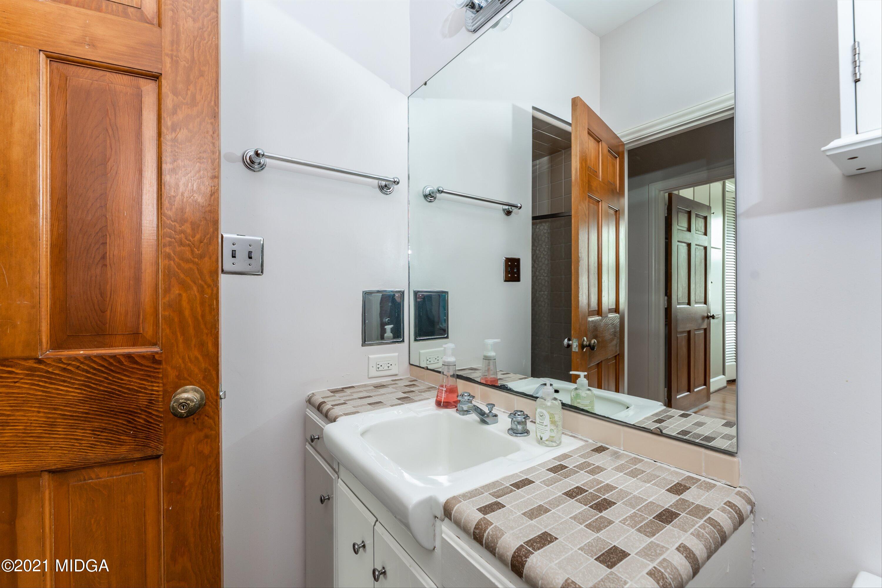 1845 Lincoln Road Macon, GA 31211 - Photo 26 of 31 a bathroom with a sink vanity and a mirror
