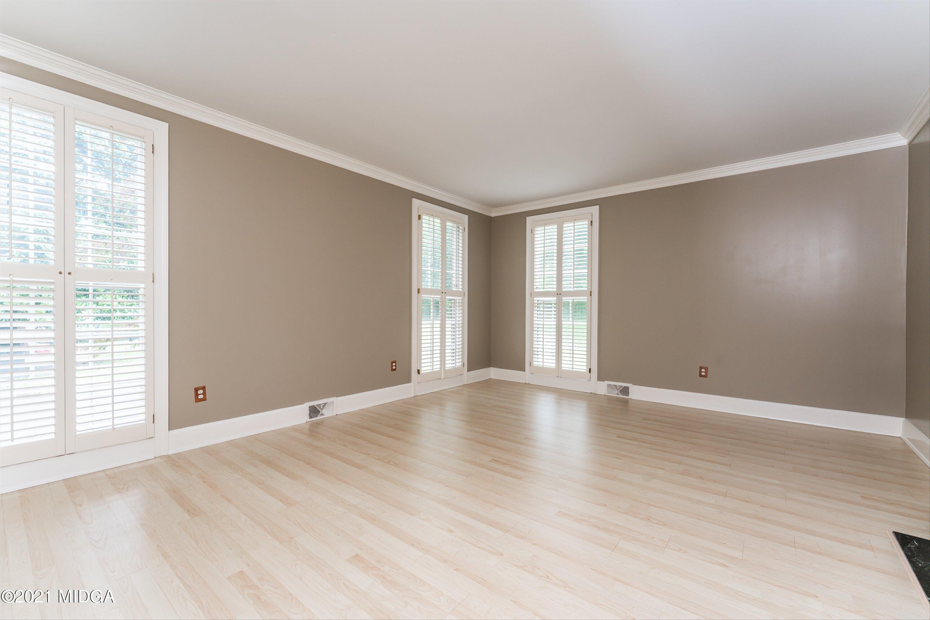 1845 Lincoln Road Macon, GA 31211 - Photo 10 of 31 a view of an empty room with wooden floor and a window