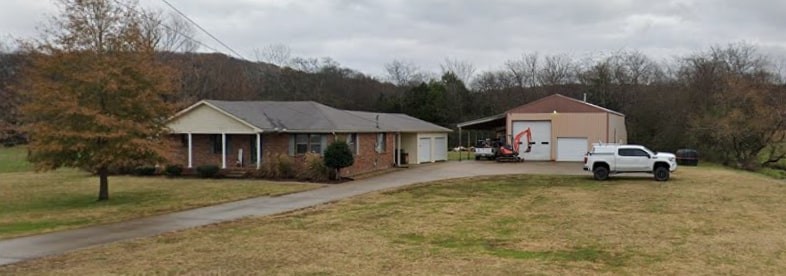1595 Spring Creek Road Lebanon, TN 37087 - Photo 2 of 2 a view of a white house with a big yard and large trees