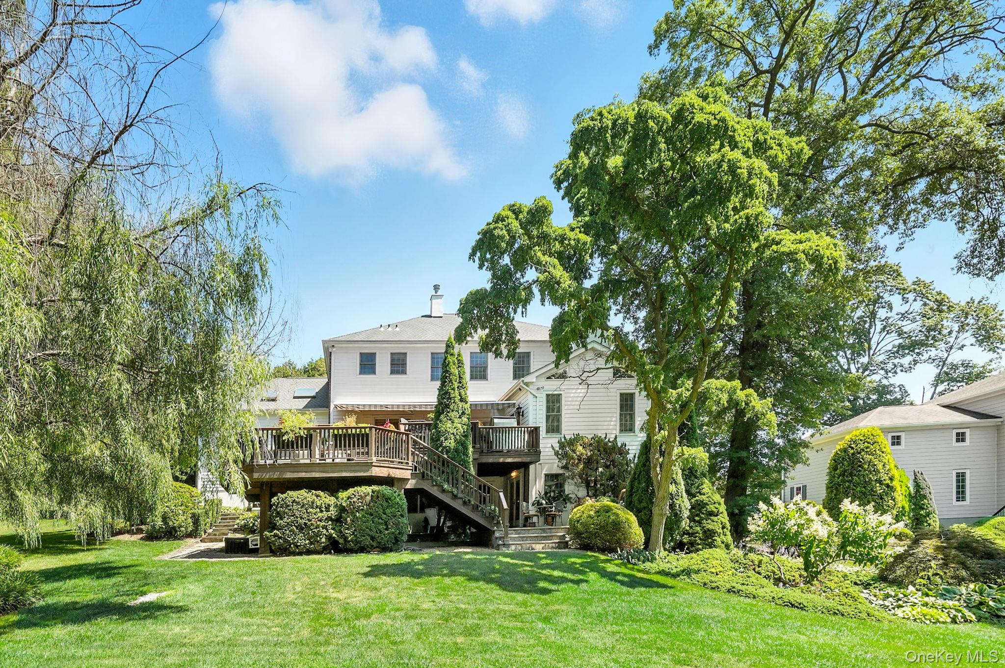 33 Hevelyne Road Elmsford, NY 10523 - Photo 39 of 43 Rear view of property with stairs, a wooden deck, and a lawn