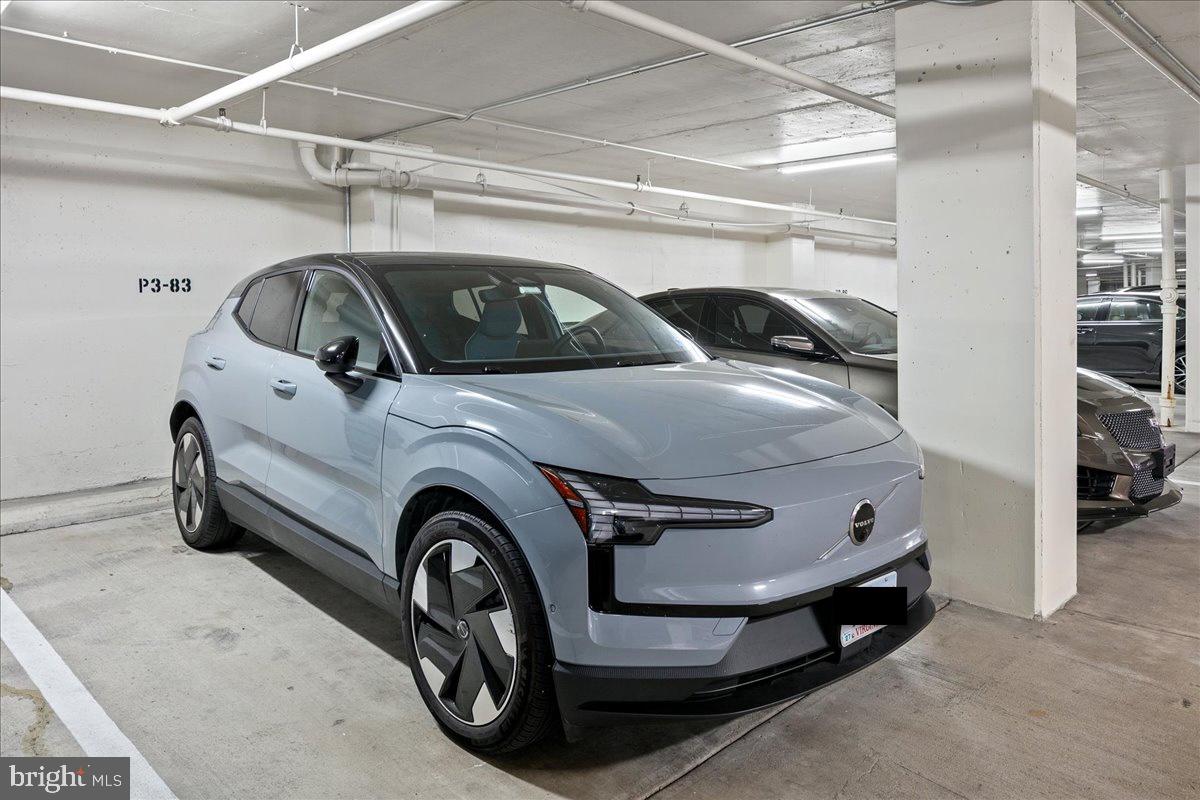 1101 South Arlington Ridge Road, Unit 402 Arlington, VA 22202 - Photo 48 of 61 Sleek electric vehicle in modern garage.
