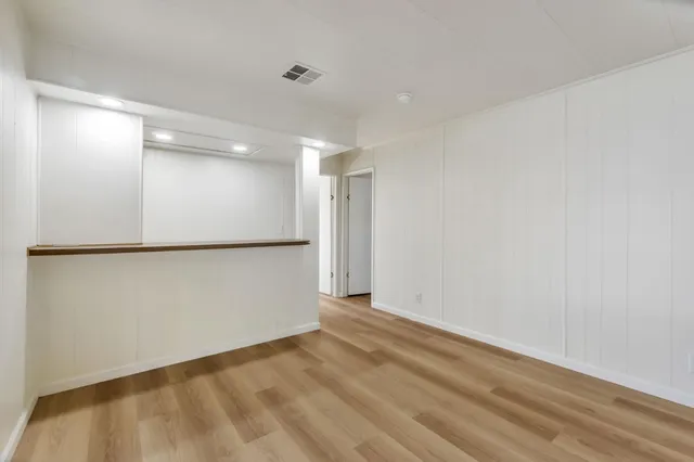 a view of a kitchen with wooden floor and electronic appliances