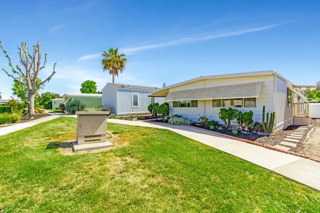 a front view of house with a garden and yard