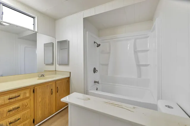 a spacious bathroom with a double vanity sink and a mirror