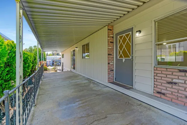 a kitchen with a refrigerator a sink and wooden floor