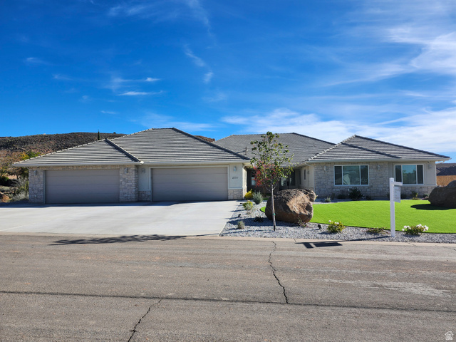 230 Boulder Way Leeds, UT 84746 - Photo 1 of 72 Single story home with driveway, a 5 car garage, a front lawn, and stone siding & night lighting.