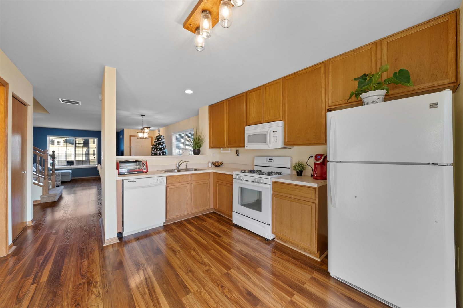 2431 Roxbury Lane Montgomery, IL 60538 - Photo 6 of 13 a kitchen with a refrigerator a stove top oven and a sink