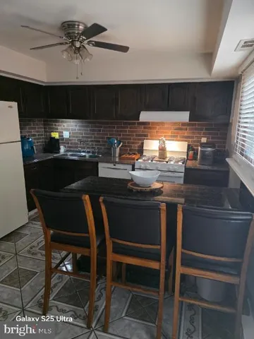 a kitchen with a stove and a refrigerator