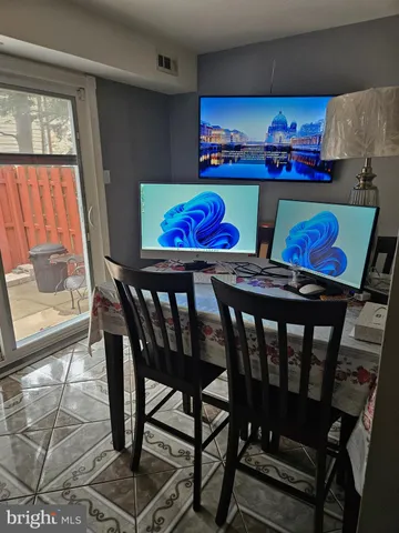 a view of a dining room with furniture a rug and wooden floor