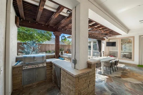 a view of a patio with a table and chairs