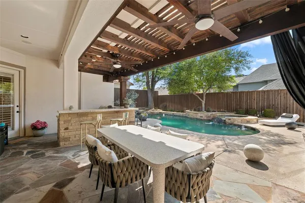 a view of a house with backyard porch and sitting area